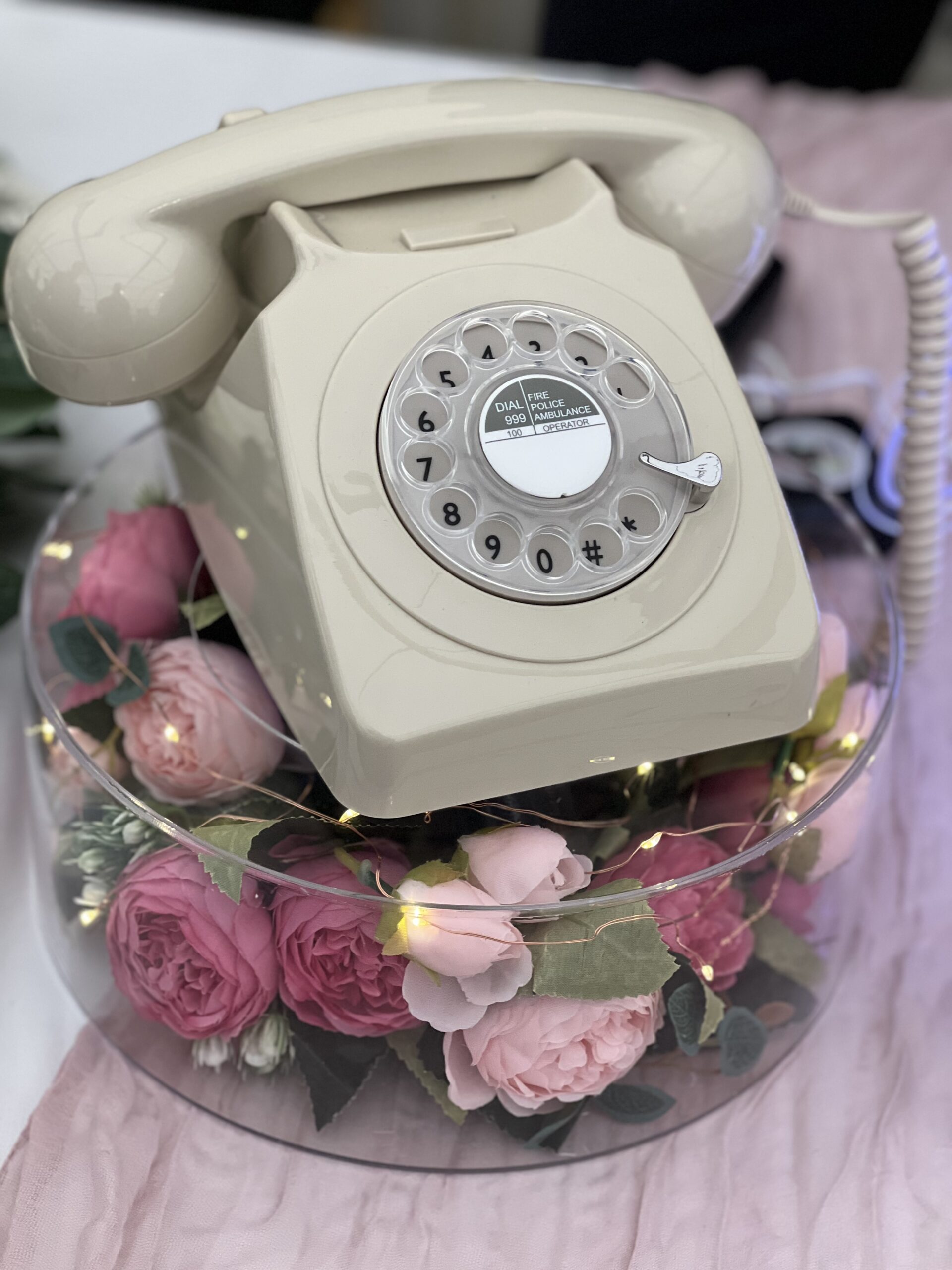 ivory retro telephone audio guestbook upon a floral wedding stand