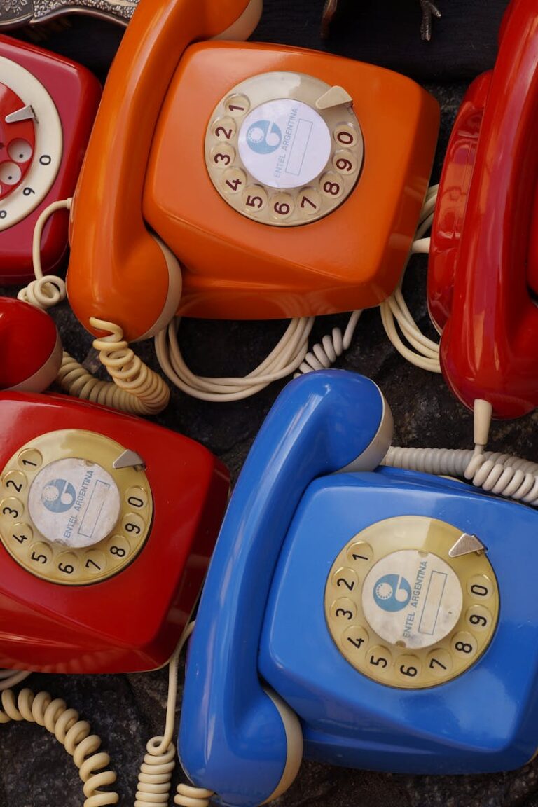 A collection of colorful vintage rotary telephones evokes nostalgic charm and retro style.