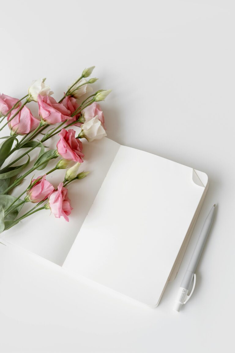 Open Written Guest Book with pink and white flowers and a pen. Perfect for Wedding guests.